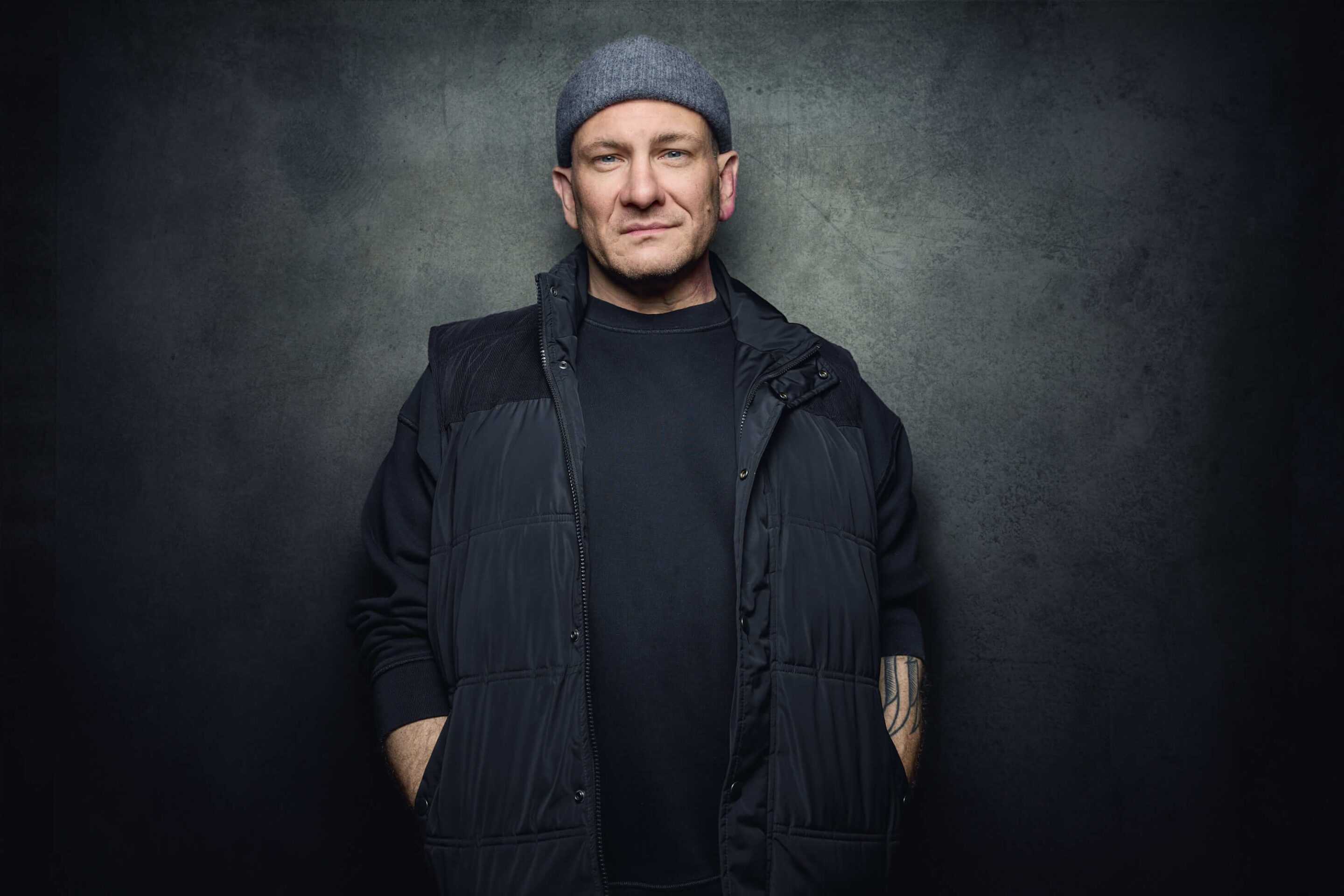 Portrait of an actor in front of a grungy studio backdrop