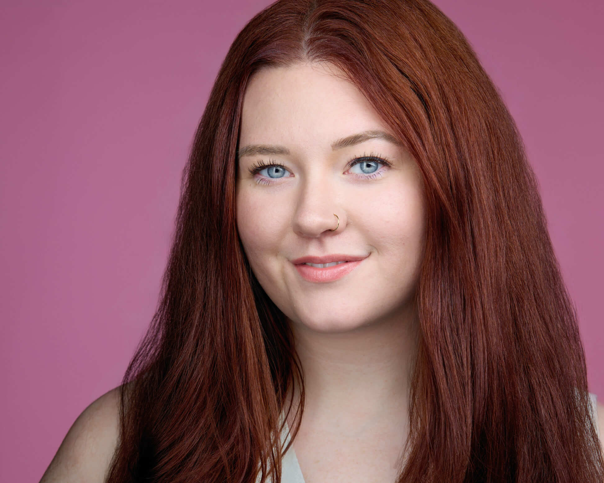 An acting headshot of Morgan Bowman on a pink backdrop