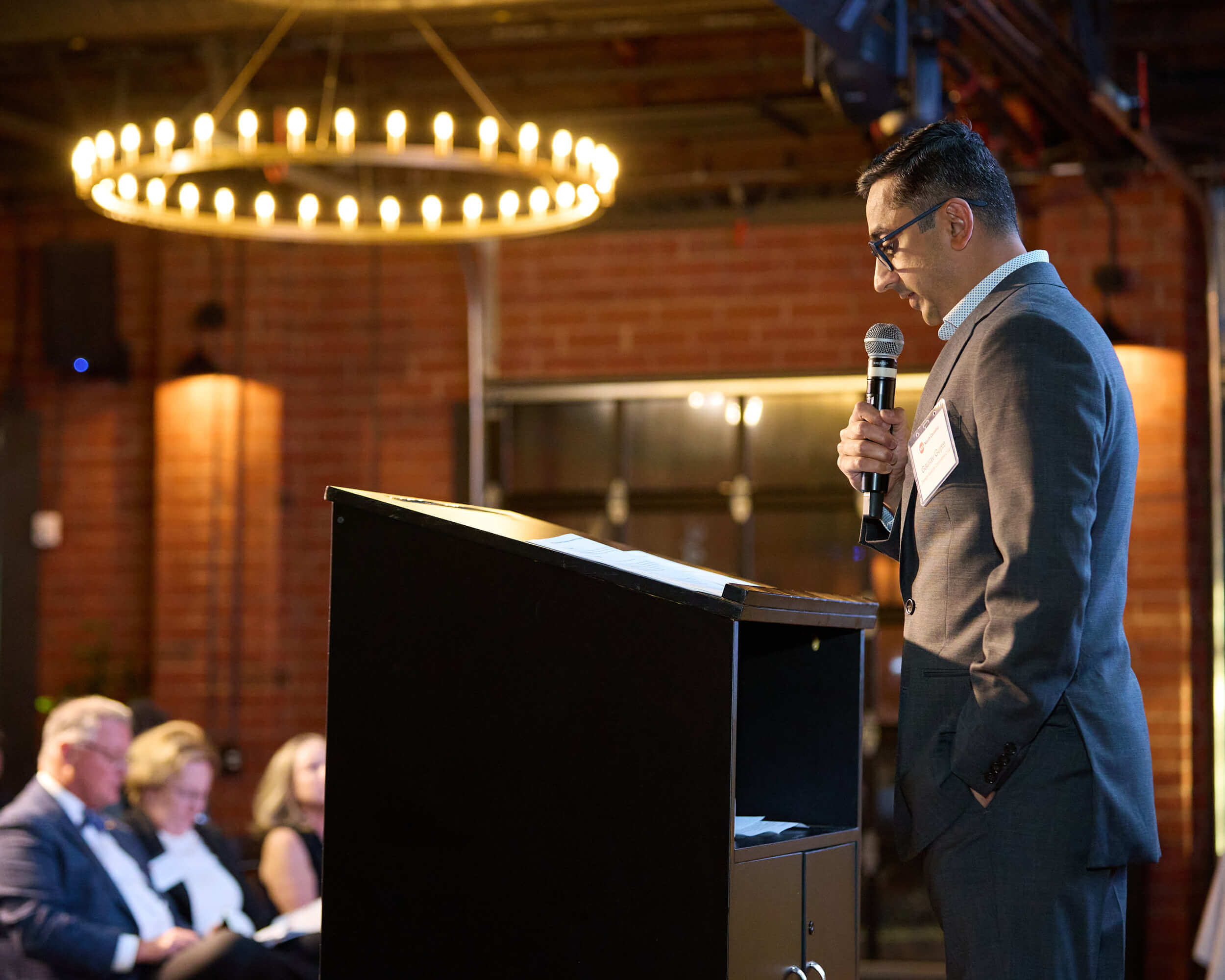 AIA North Carolina Architects Award Ceremony – Charlotte Event Photography Alt Text A speaker addressing guests at a podium during the AIA North Carolina Architects award ceremony in Charlotte.