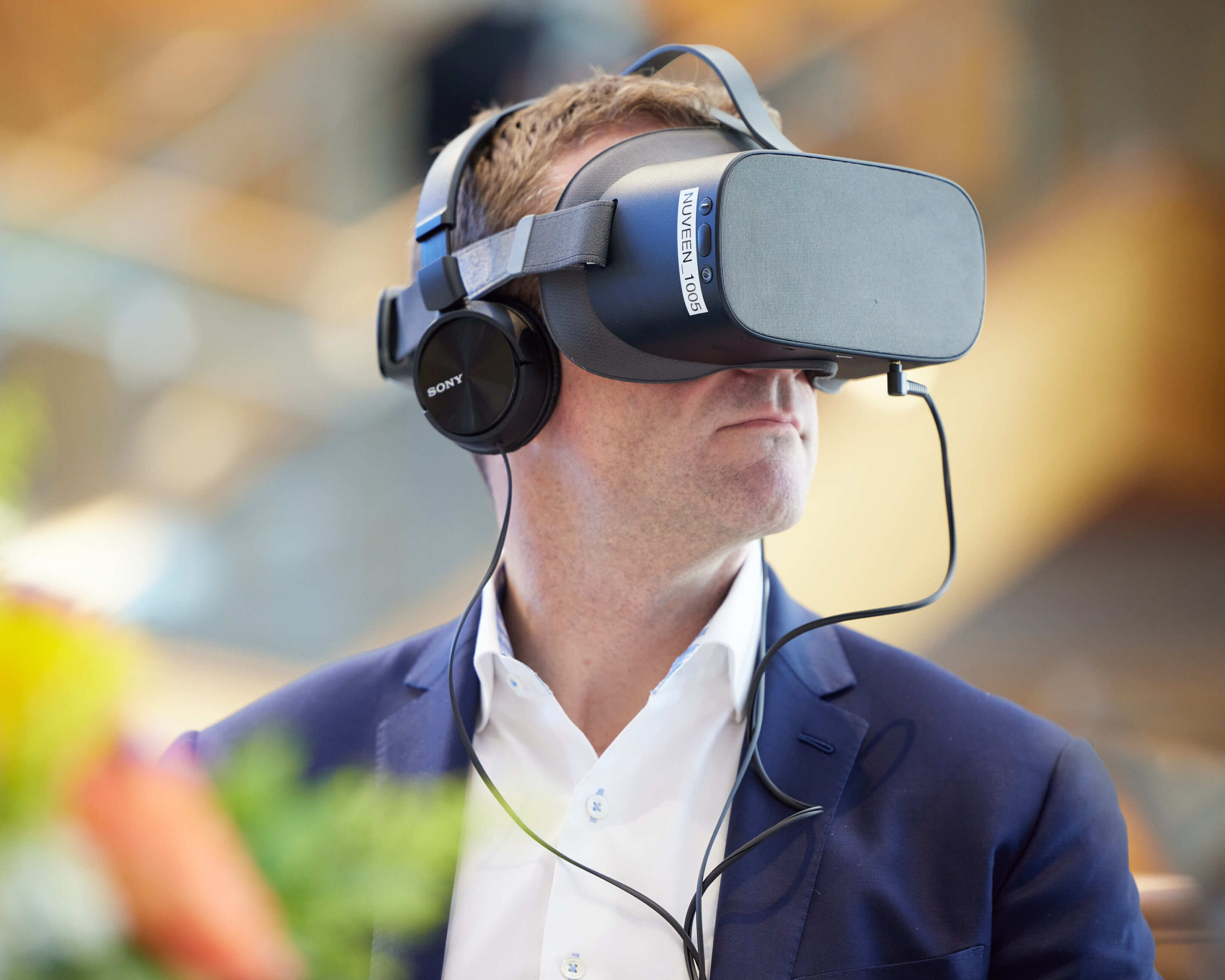 A Trane Technologies employee wearing a VR headset and testing virtual reality technology at a Charlotte corporate event.