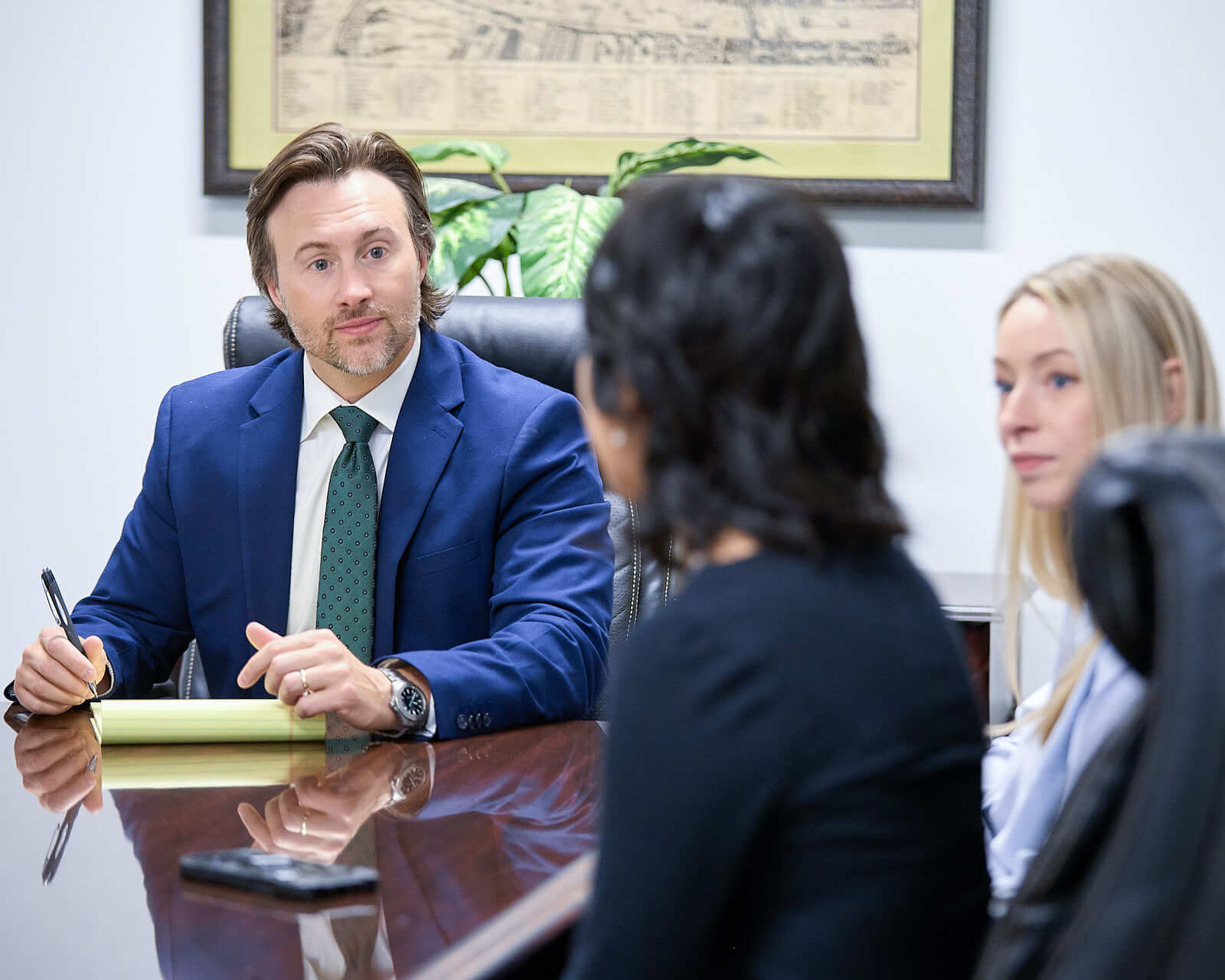 Auger & Auger Law Firm Client Consultation – Charlotte Corporate Photography An Auger leading a client consultation at a conference table with colleagues during a lifestyle branding session.