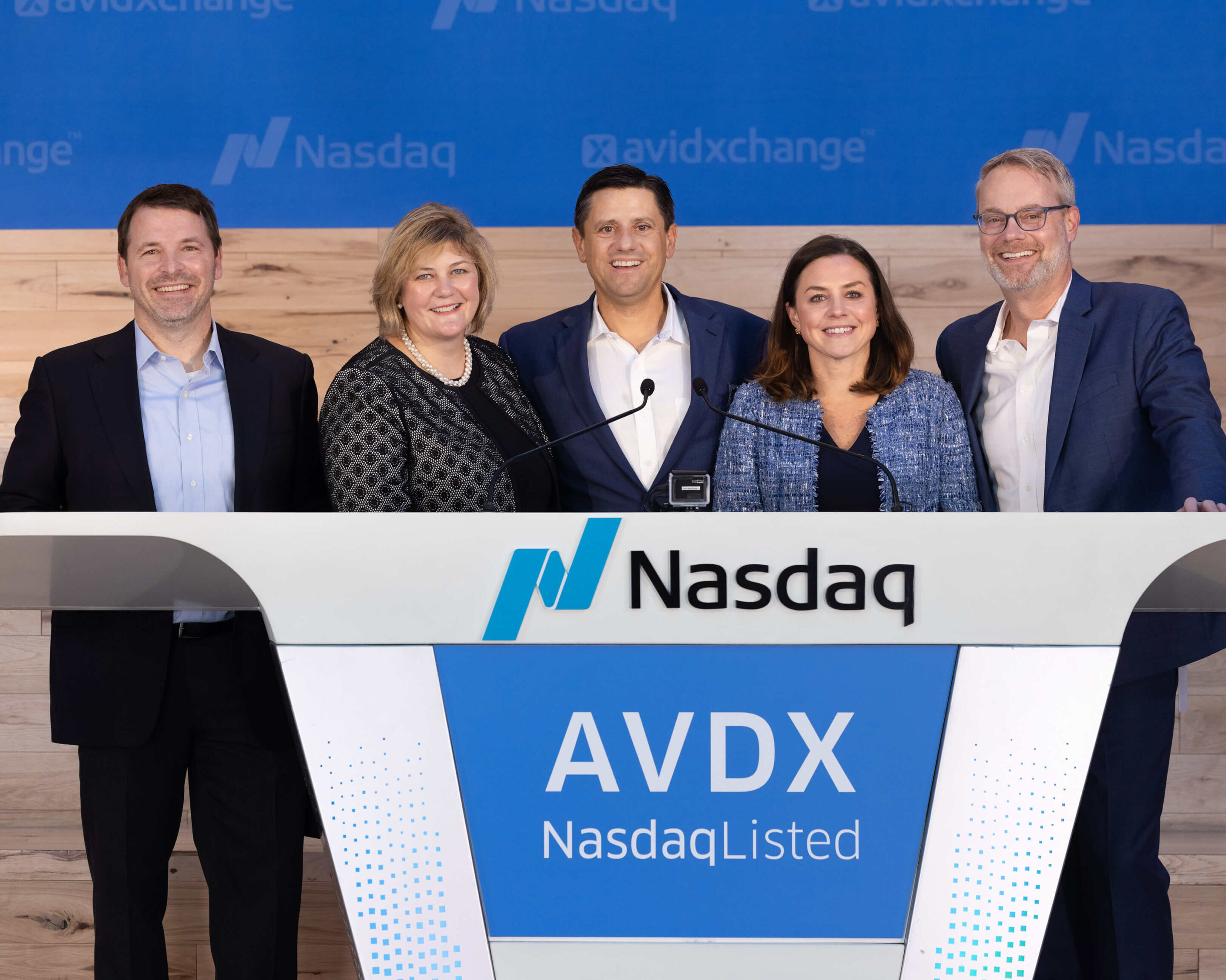AVDX Nasdaq Bell Ringing Event – Charlotte Corporate Event Photography Alt Text Group of executives posing on stage at the Nasdaq bell ringing event for AVDX going public in Charlotte, NC.